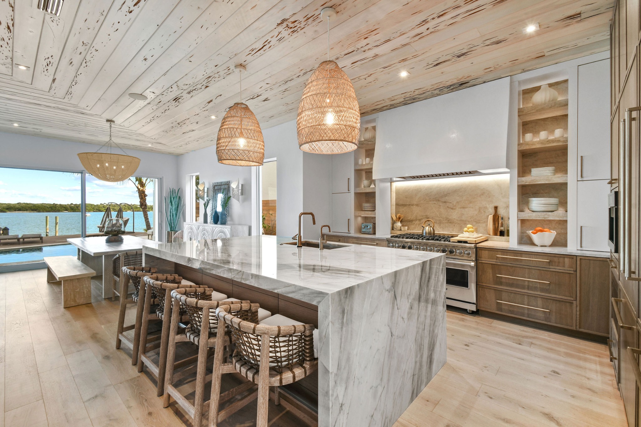 Luxury waterfront kitchen with marble island and custom cabinetry